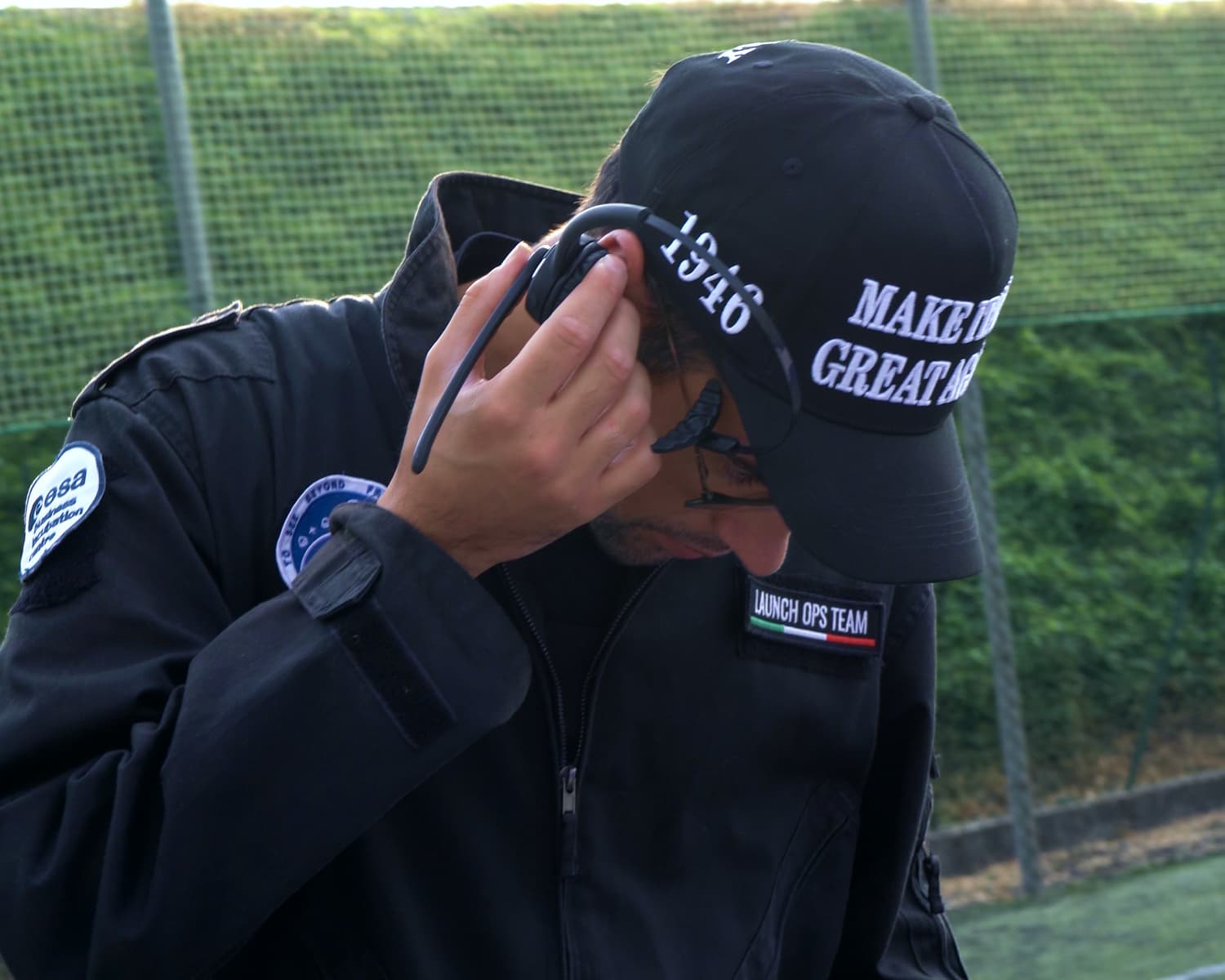 Involve Space team member adjusting a headset while wearing a MIGA cap